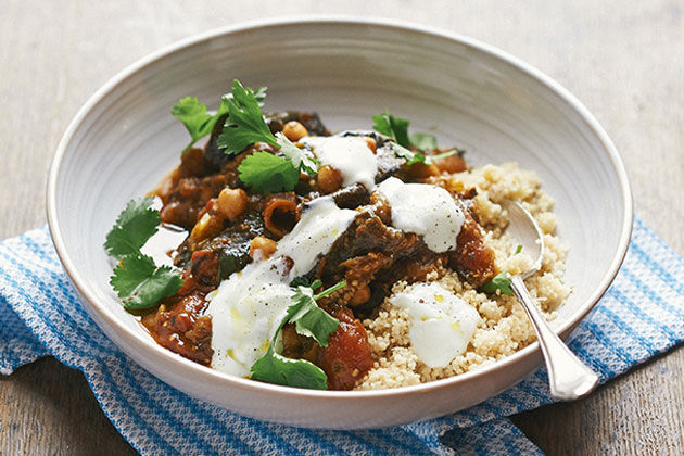 vegetarian aubergine tagine with cous cous and sour cream on top