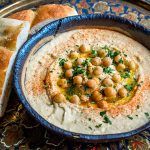 houmous with olive oil, chickpeas and bread for dipping