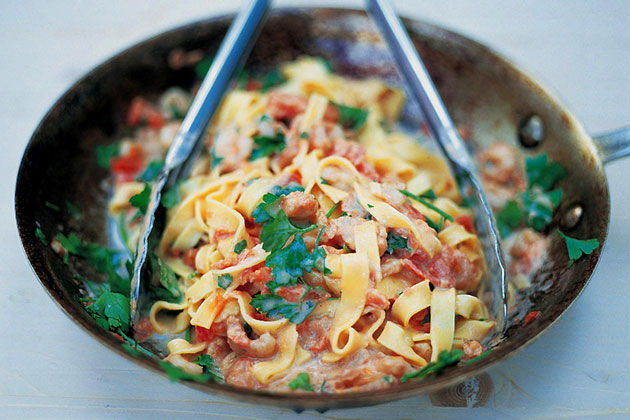 taglierini with tomato sauce and herbs in a pan