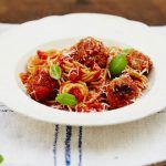 meatballs with spaghetti and basil on top