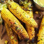 corn on the cob covered in marinade and sauce