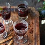 mulled wine in glasses with spices beside it