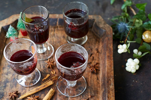 mulled wine in glasses with spices beside it