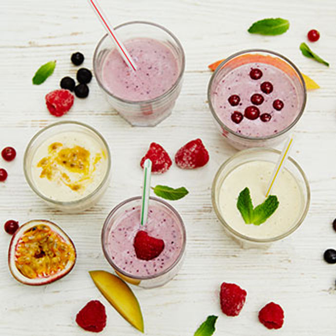 fruit smoothies surrounded by fruit