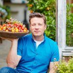 jamie oliver holding a bowl filled with home grown tomatoes - grow tomatoes feature