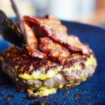 ultimate burger recipe with mustard beef burger and bacon on top