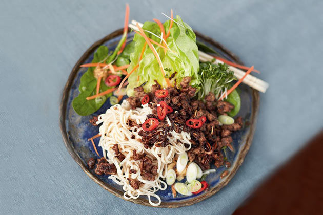 asian beef with noodles, chilli and salad