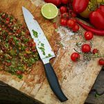 kitchen chopping board with fresh herbs and tomatoes and chilli