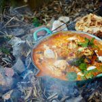 indian curry recipe cooked outside on stove with bread