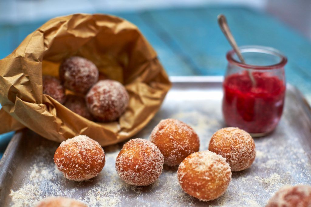 Bonfire night bakes - Mini doughnut balls coated in sugar with raspberry sauce on the side