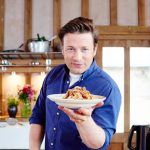 spaghetti bolognese held by jamie oliver in a bowl