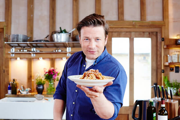 spaghetti bolognese held by jamie oliver in a bowl