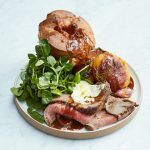 Plate of Yorkshire puddings, slices of roast beef and salad