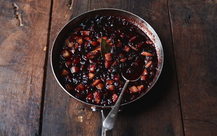 A pan of cranberry sauce on a wooden table