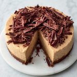 Banoffee cheesecake with chocolate curls on top, from our favourite cheesecake recipes