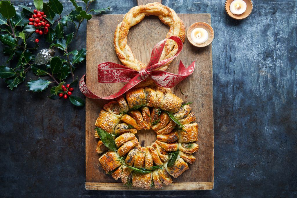 Festive sausage roll wreath on a chopping board