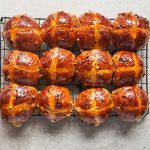 12 hot cross buns on a cooling rack