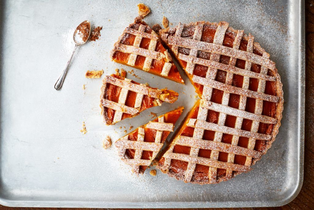 Halloween cake: latticed pumpkin pie cut into slices with a spoon