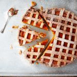 Halloween cake: latticed pumpkin pie cut into slices with a spoon