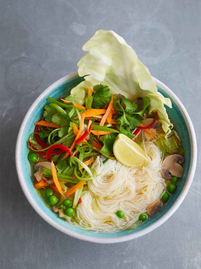 A bowl of aromatic veg broth with rice noodles, 5 spice and coriander.