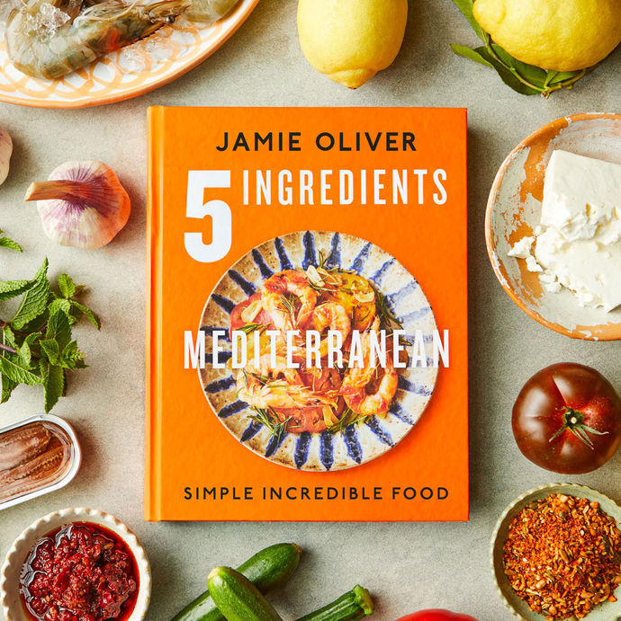 5 Ingredients Mediterranean book cover surrounded by Mediterranean ingredients like feta, lemons, prawns and courgettes