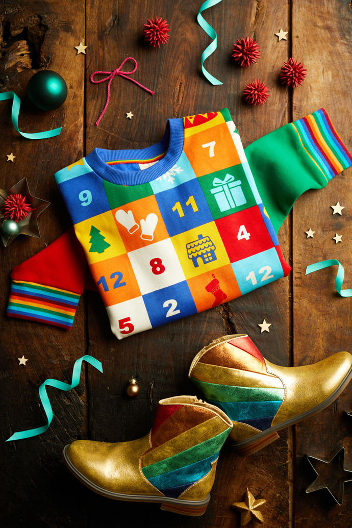 Little Bird children's jumper with a multi-coloured patchwork advent calendar design, and gold children's ankle boots with a rainbow design