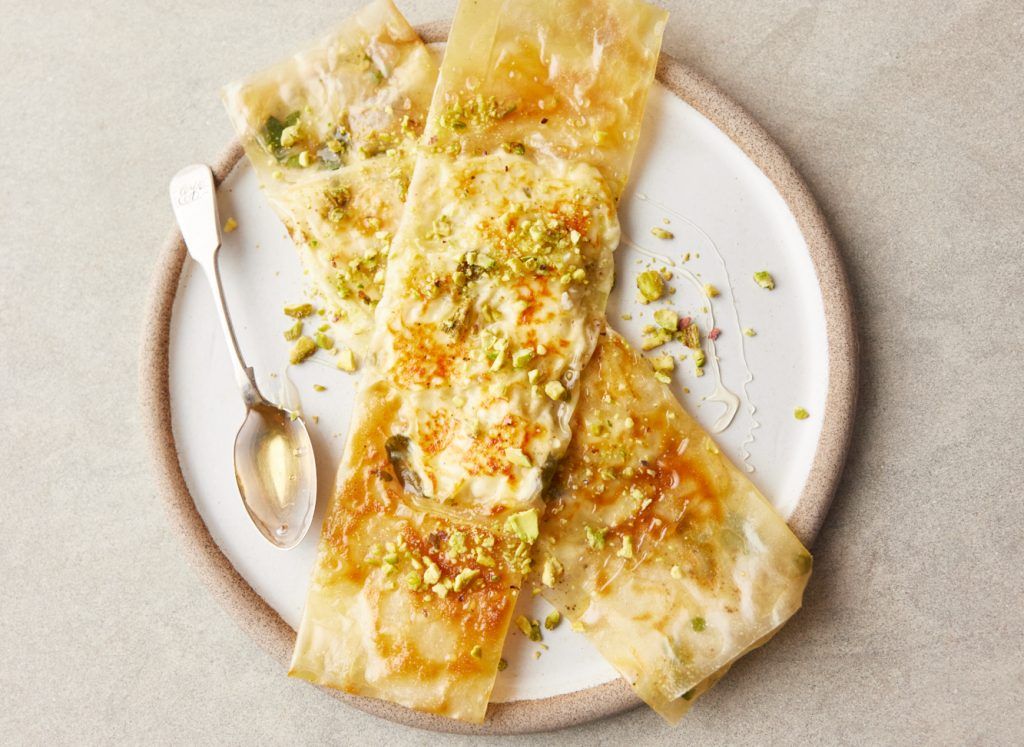 Easy dinner party recipes - Feta filo parcels on a plate, with honey and pistachios drizzied over it