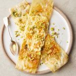 Easy dinner party recipes - Feta filo parcels on a plate, with honey and pistachios drizzied over it