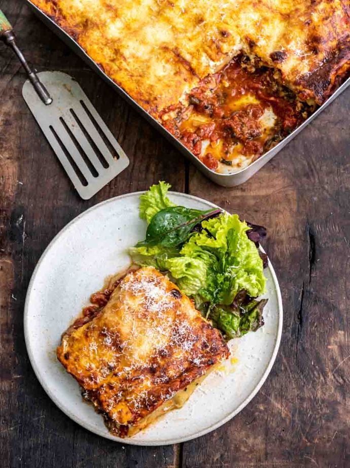 Oozy cheesy cannelloni wedge on a plate, just served from the tray