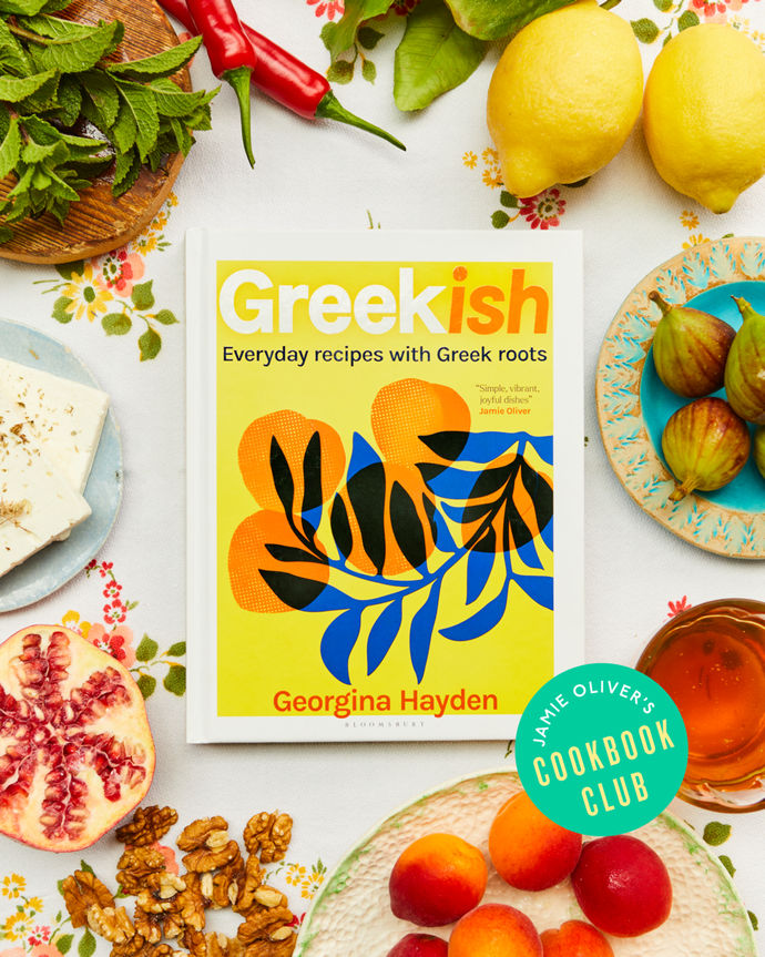 Cookbook club July - Greekish by Georgina Hayden. Flat lay of cookbook surrounded by ingredients including lemons, pomegranate, figs and more