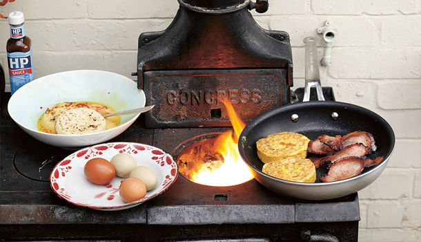 breakfast recipe - eggs, bacon and crumpets fried on a wooden fire
