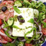 greek salad with cheese, olives, tomatoes and herbs