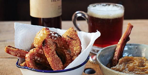 pork crackling with apple sauce next to beer