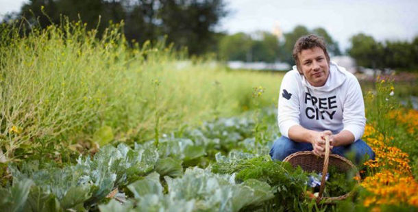 jamie oliver in a vegetable garden with a basket