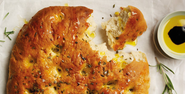 focaccia with herbs on top and balsamic vinegar in oil for dipping