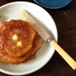 gluten-free pancakes with melted butter on top and syrup