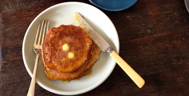 gluten-free pancakes with melted butter on top and syrup
