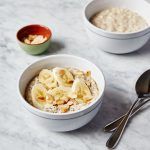 oatmeal porridge with seeds, nuts and banana on top