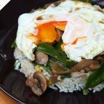 poached egg on rice and mushroom veggie stir fry dish