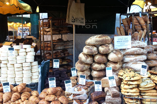 market with stacks of fresh breads, pastries and bakes