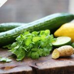 Green juice ingredients, cucumber, lemon, lime, herbs, ginger