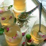 iced tea with alcohol added and rose buds in the drinks