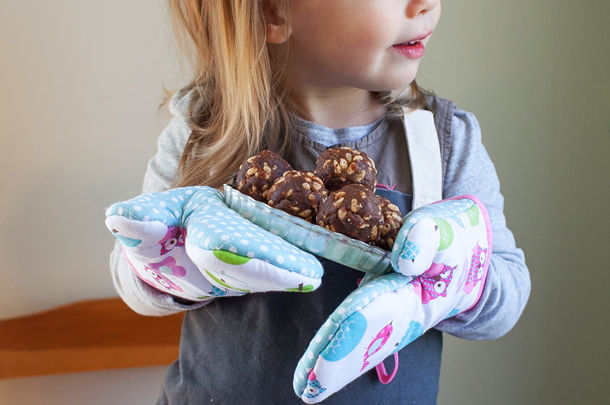 child holding plate with chocolate bakes