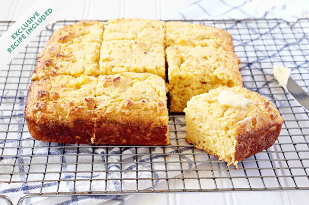 cornbread sliced into squares with butter on top