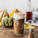 homemade pumpkin spice latte in glass with foam on top