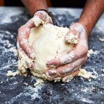 hands kneading pastry dough