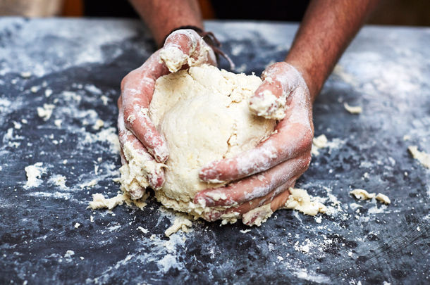 hands kneading pastry dough