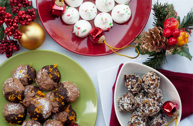 christmas desserts, truffles, cookies and baubles on a table