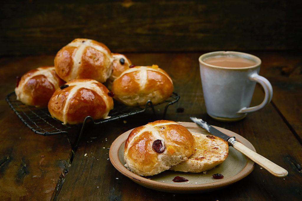 homemade hot cross buns toasted with butter and tea