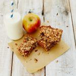 milk with granola bars and an apple